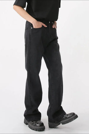 Dark denim wide-leg trousers with vertical seams and a relaxed fit.