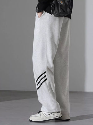 Light Flower Gray sweatpants with black stripes detail and loose fit.