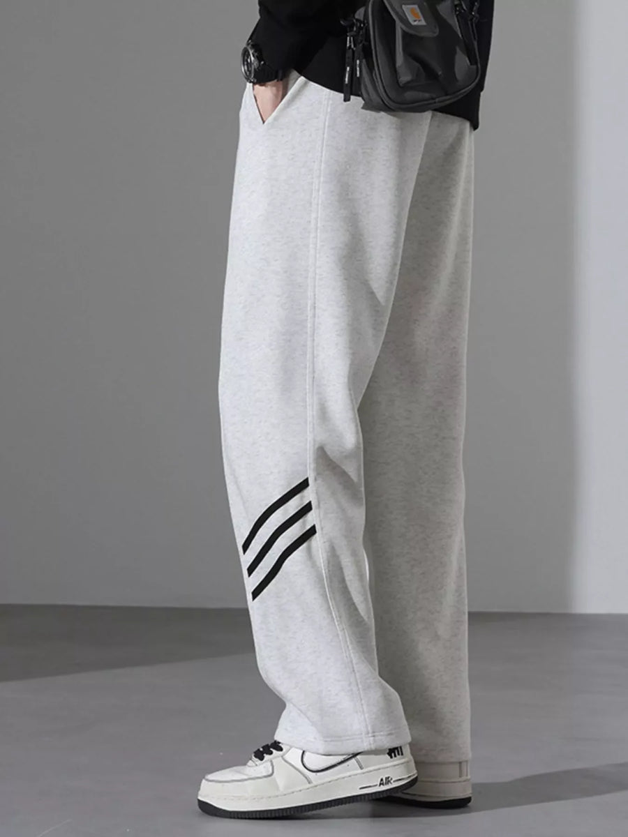 Light Flower Gray sweatpants with black stripes detail and loose fit.