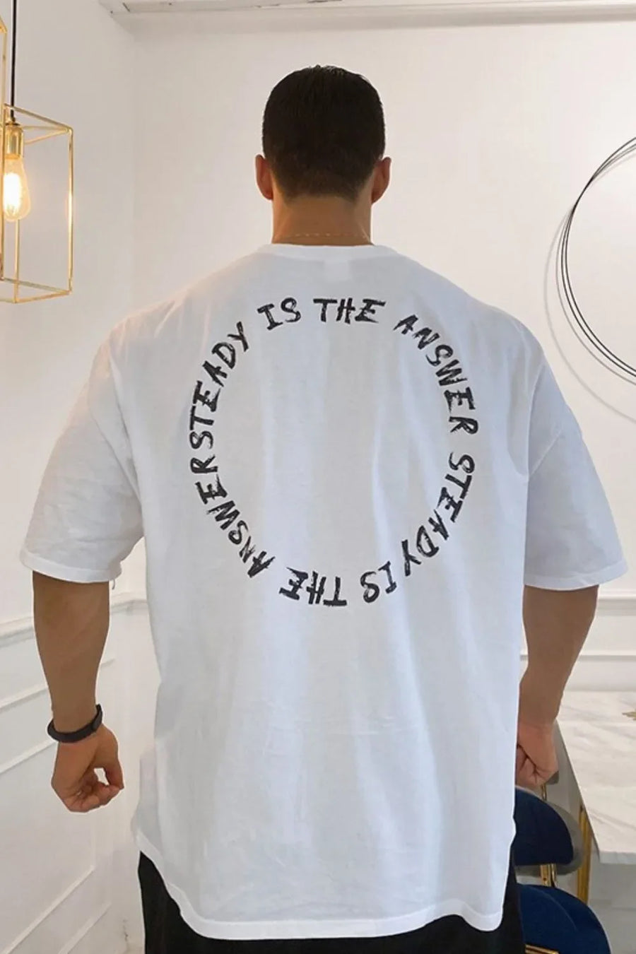Men's oversized white t-shirt with black circular text graphic on back