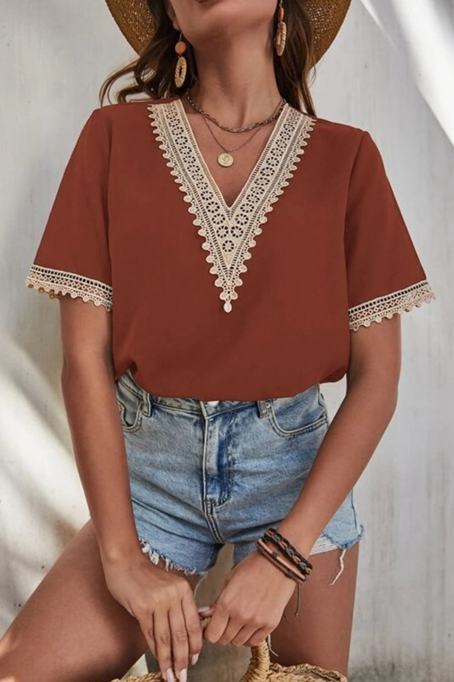 Brown V-neck blouse with lace trim on neckline and sleeves