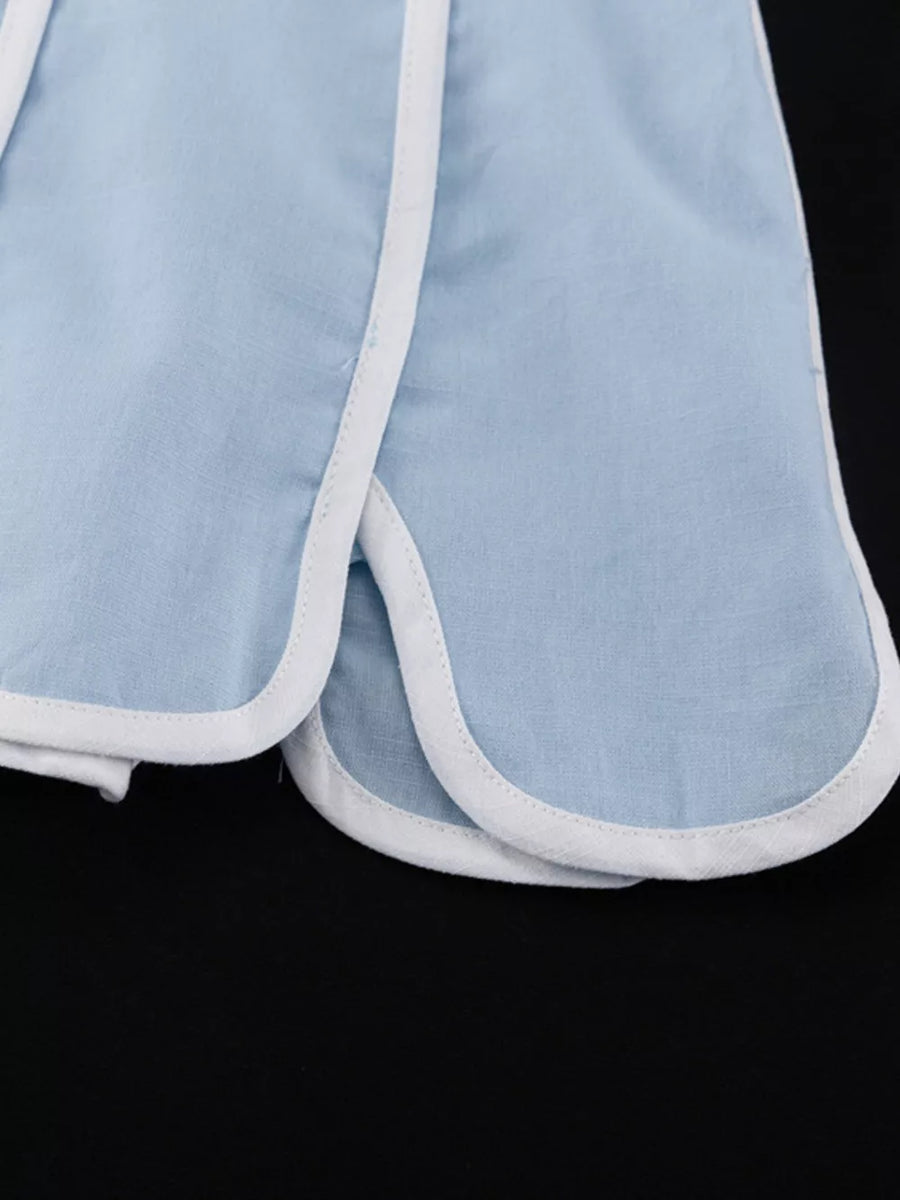 Light blue cotton shorts with white piping and curved hem