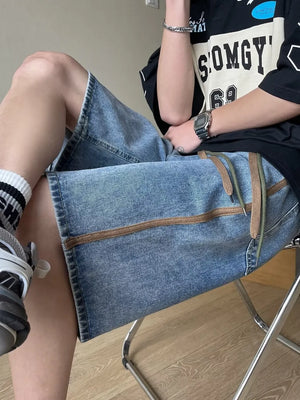 Men's blue wide-leg denim shorts with drawstring and contrast stitching detail.