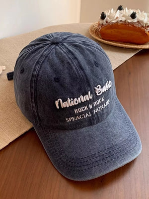 Navy blue washed baseball cap with white embroidered text.