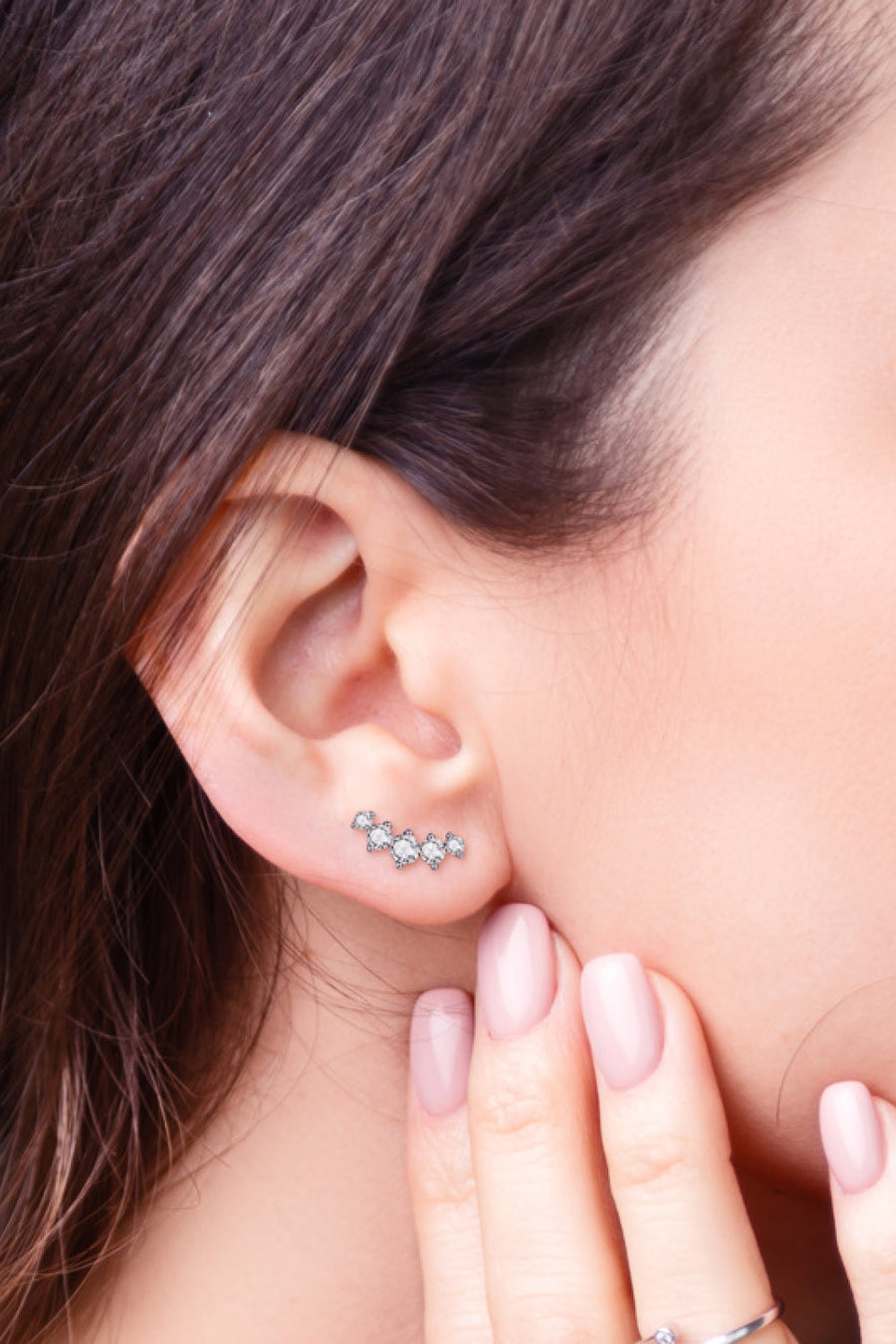 Silver celestial cluster stud earrings with clear stones on ear