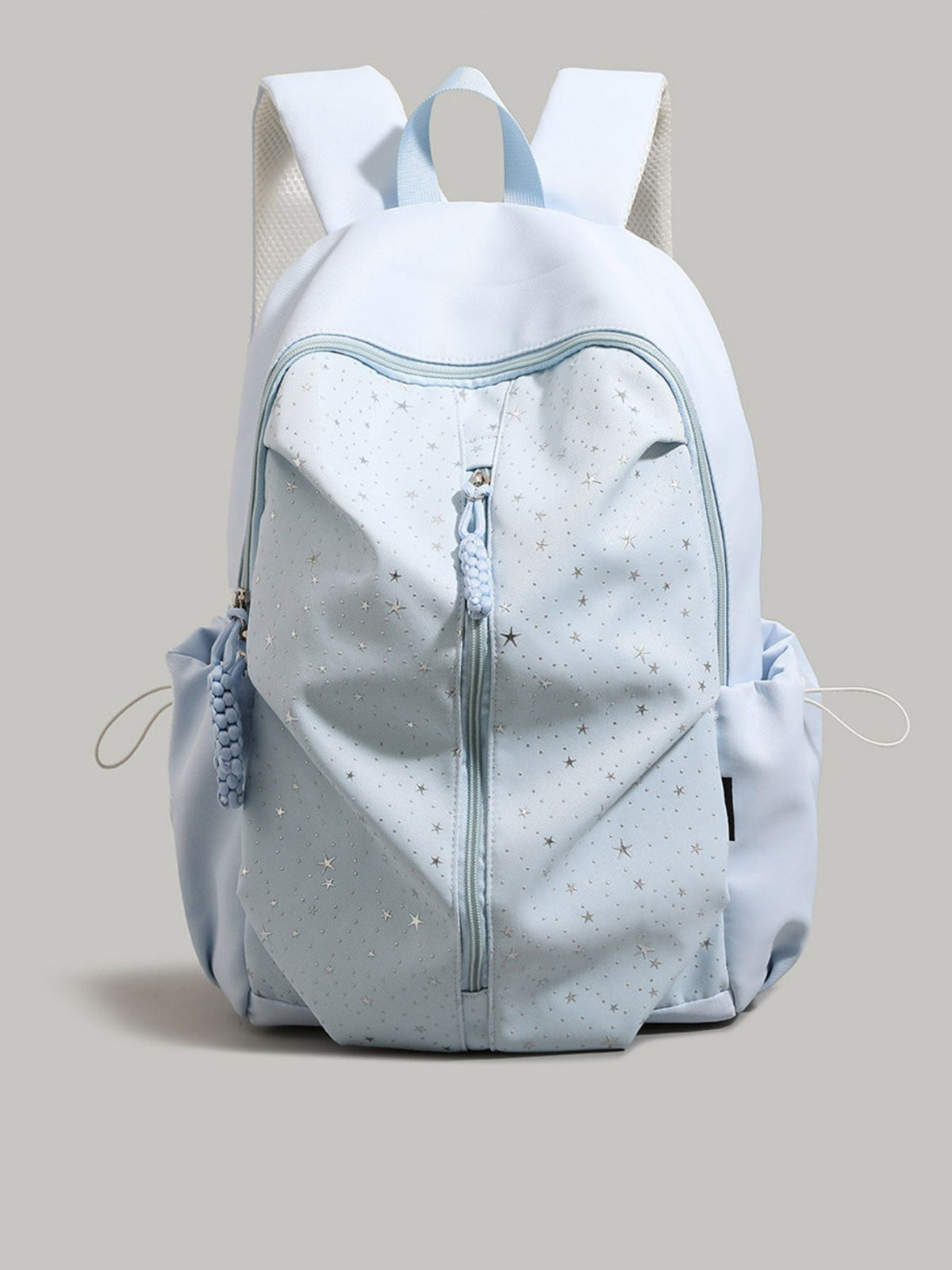 Light blue nylon school backpack with silver stars and braided zipper pulls.