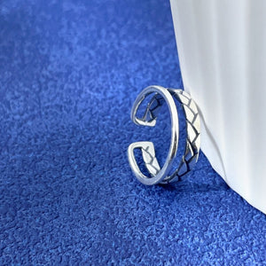 Silver ring featuring open cuff and braided
