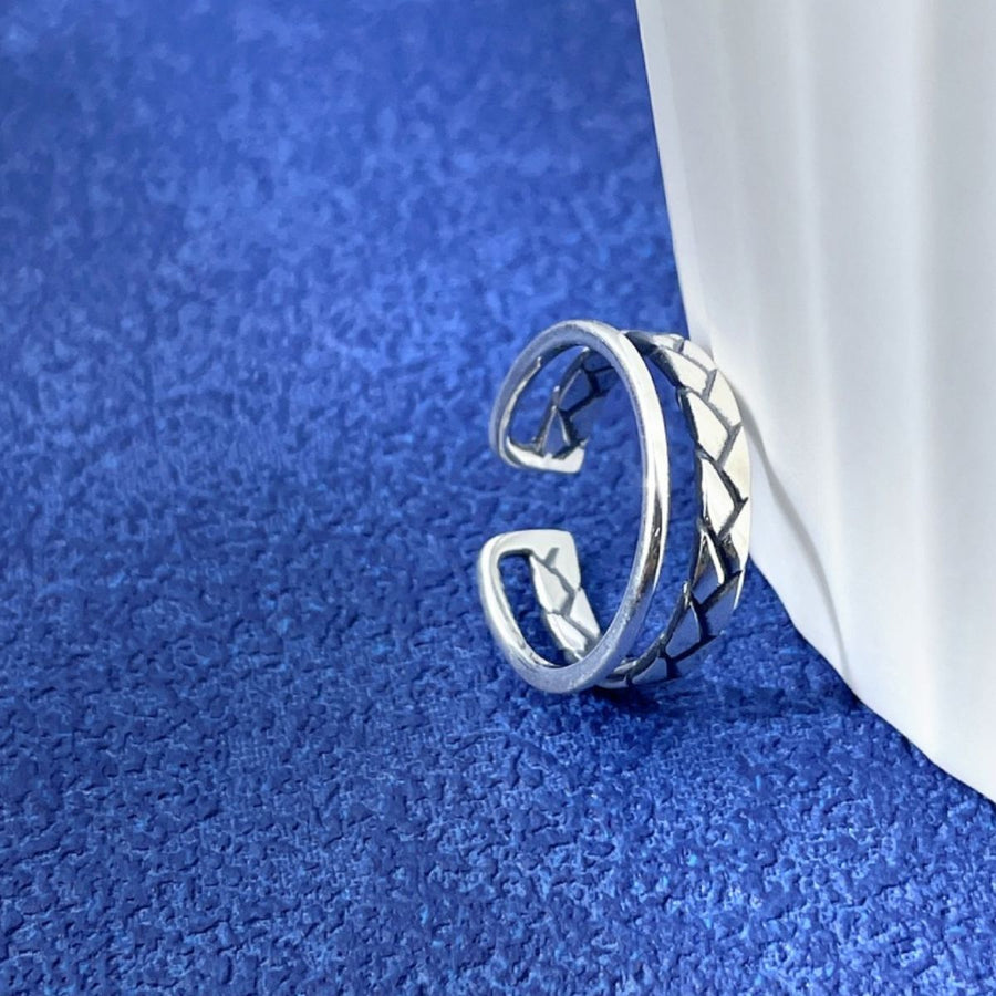 Silver ring featuring open cuff and braided