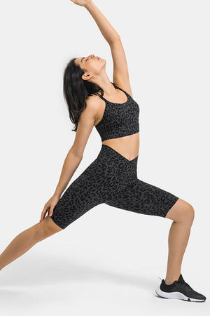 V-waist biker shorts in black leopard print with side pockets.