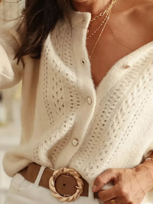 Cream eyelet knit button-down cardigan with pearl buttons, styled with a brown belt.