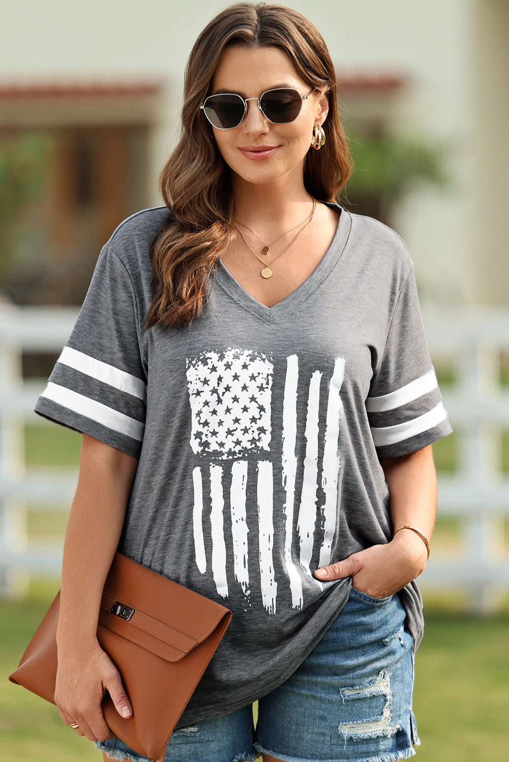 Dark gray v-neck tee with distressed American flag graphic and white sleeve stripes.