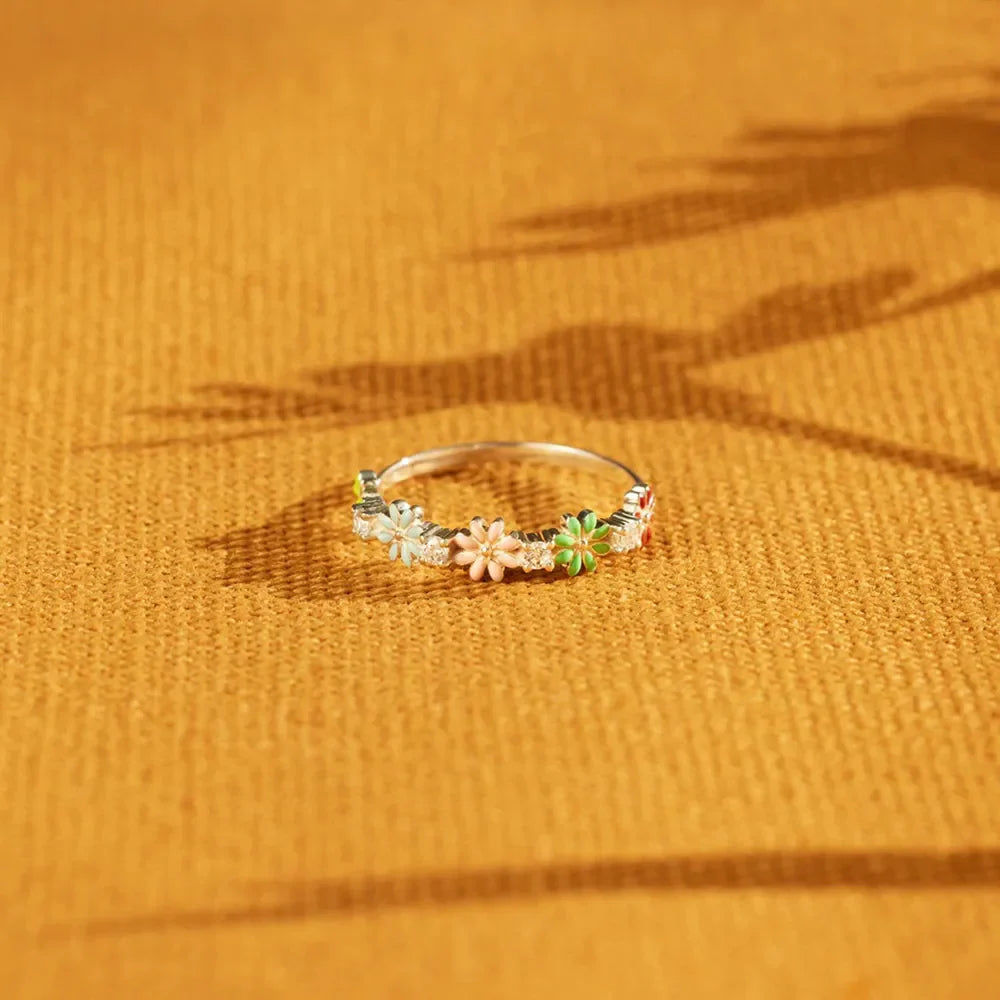 Silver ring with colorful enamel floral cluster and clear accent stones