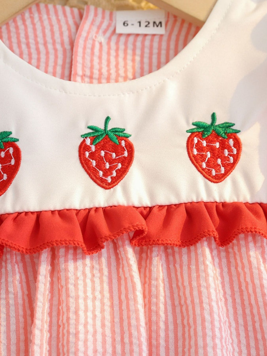 Baby dress with embroidered strawberries and red ruffle trim on striped cotton fabric.