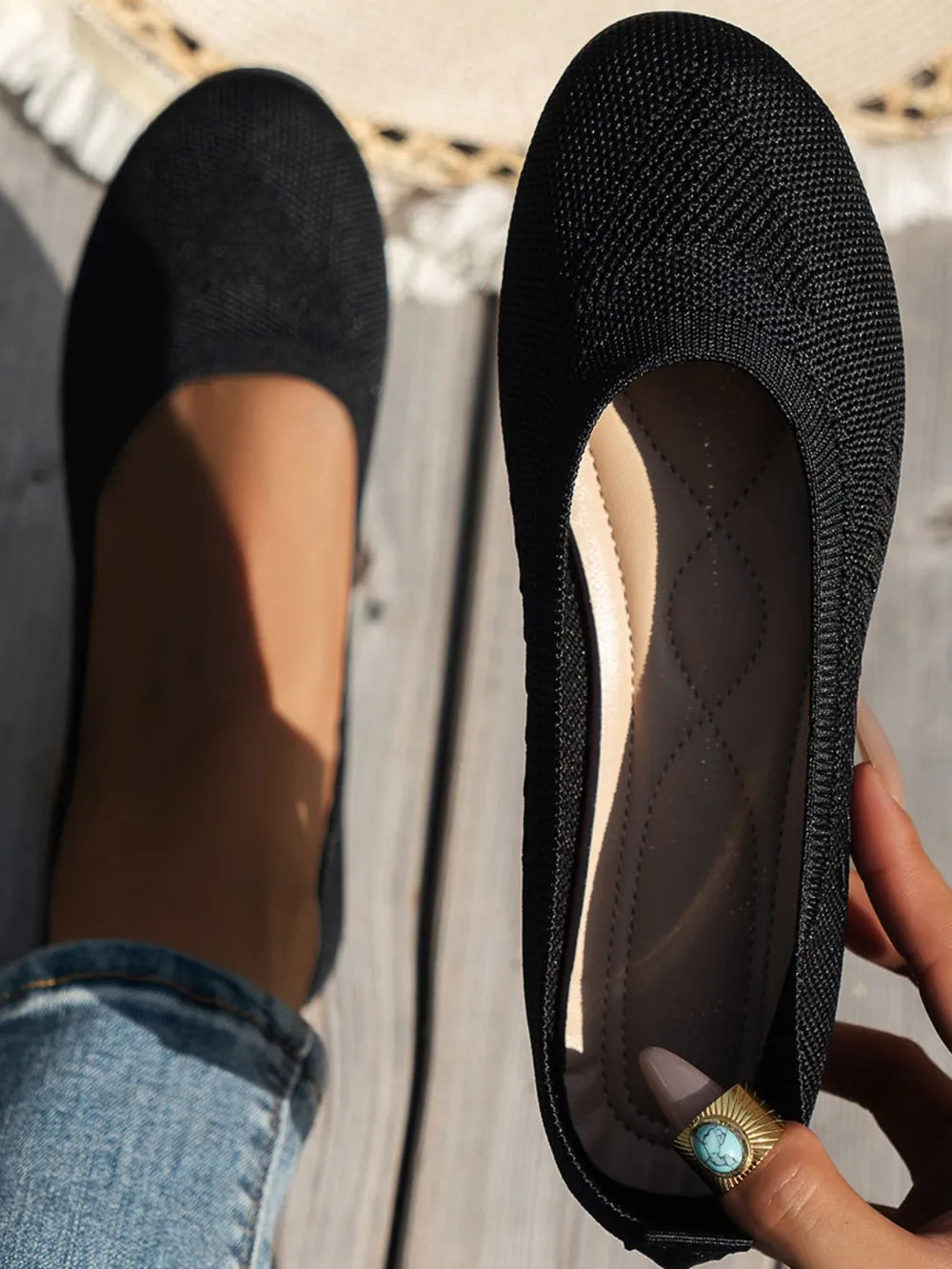 Black textured knit ballet flats with a cushioned insole.