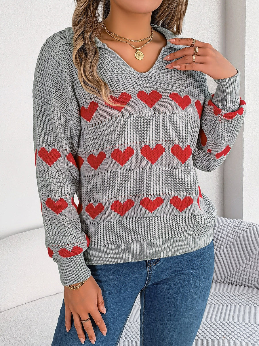 Gray knit polo sweater with red heart stripe pattern and collared neckline.