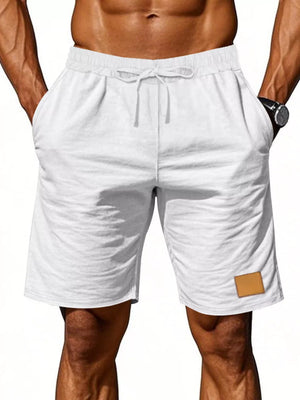 White chino shorts with drawstring waist and leather patch detail