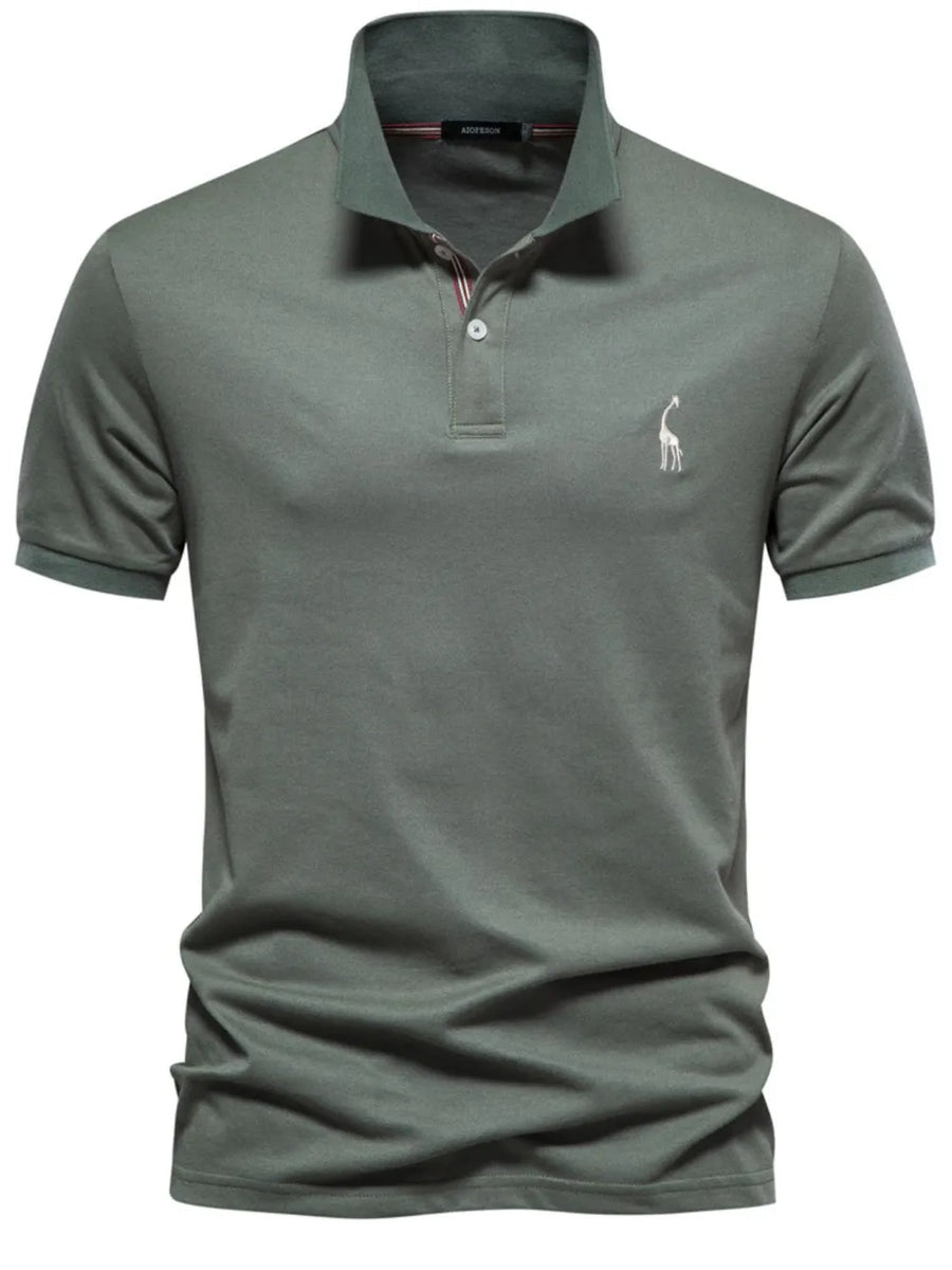 Moss green piqué polo shirt with giraffe embroidery and striped collar detail.