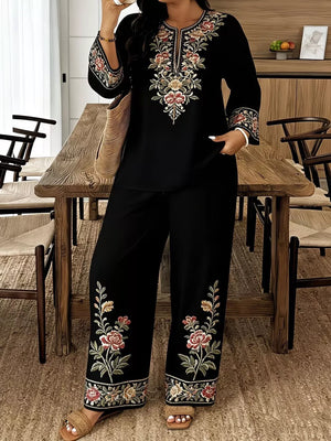 Black embroidered floral set with wide leg pants and long sleeve top.
