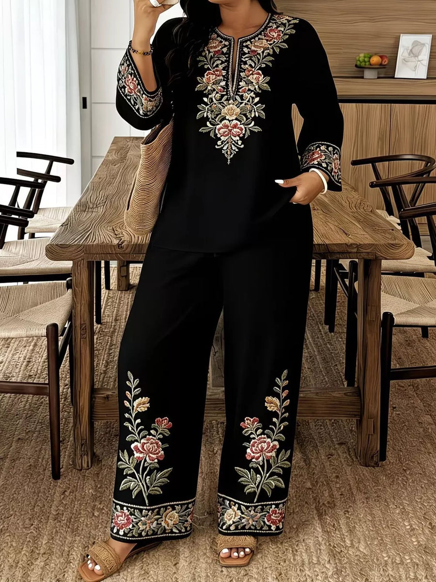 Black embroidered floral set with wide leg pants and long sleeve top.