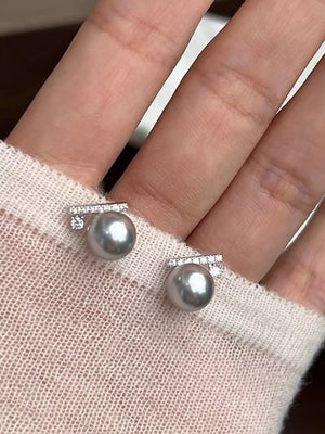 Light gray pearl stud earrings with diamond bar detail.