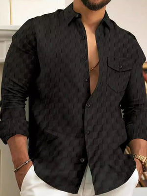 Textured black cotton button-up shirt with two chest pockets and button cuffs.