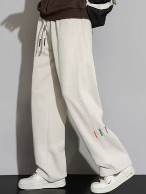 Men's apricot casual loose fit drawstring sweatpants with side detail tags.