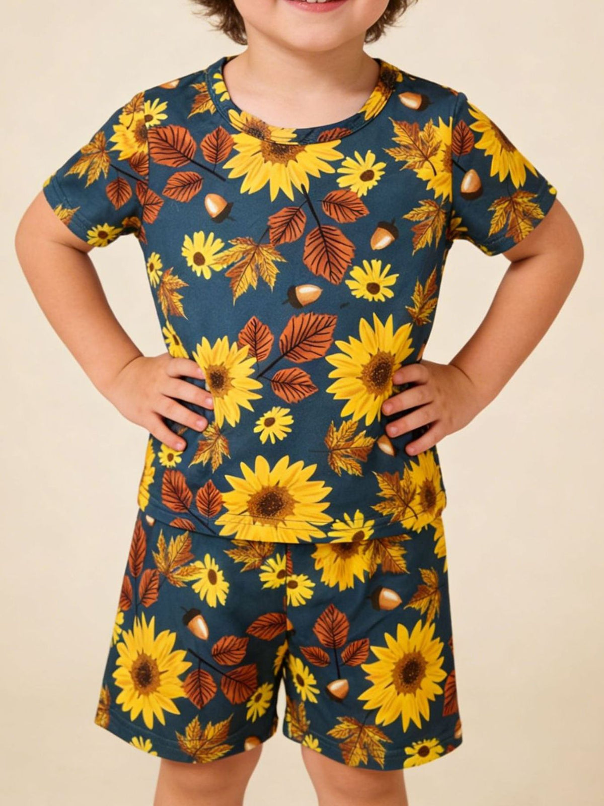 Toddler blue short sleeve t-shirt and shorts set with sunflowers, leaves, and acorns pattern.