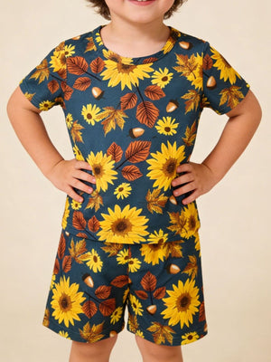 Toddler blue short sleeve t-shirt and shorts set with sunflowers, leaves, and acorns pattern.