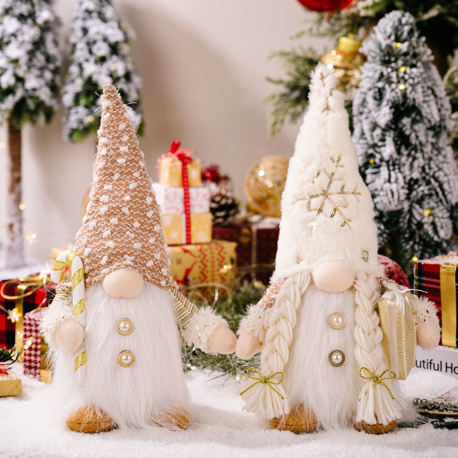 Illuminated festive gnomes with plush beards, one holding a candy cane, the other a gift.