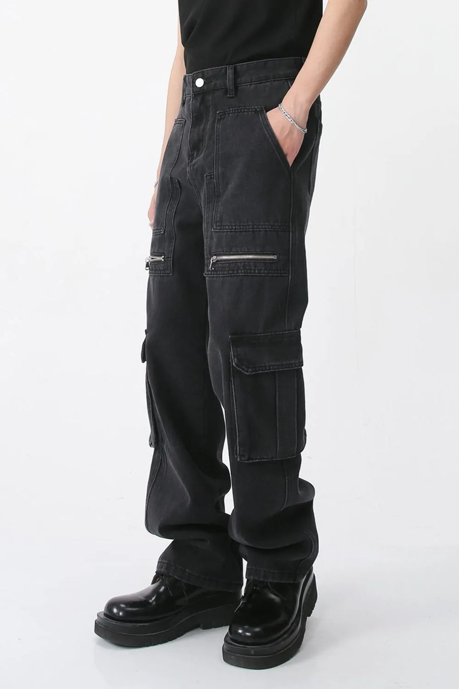 Dark denim wide-leg cargo pants with zip pockets and flap pockets.