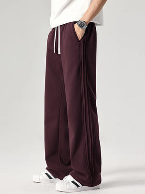 Burgundy relaxed fit men's sweatpants with drawstring and side seam detail.