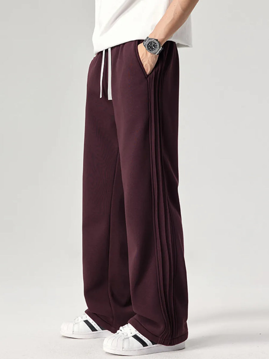 Burgundy relaxed fit men's sweatpants with drawstring and side seam detail.