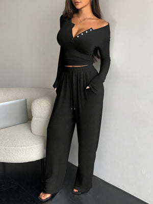 two-piece set in black featuring buttoned and fitted top, wide-leg pants fit