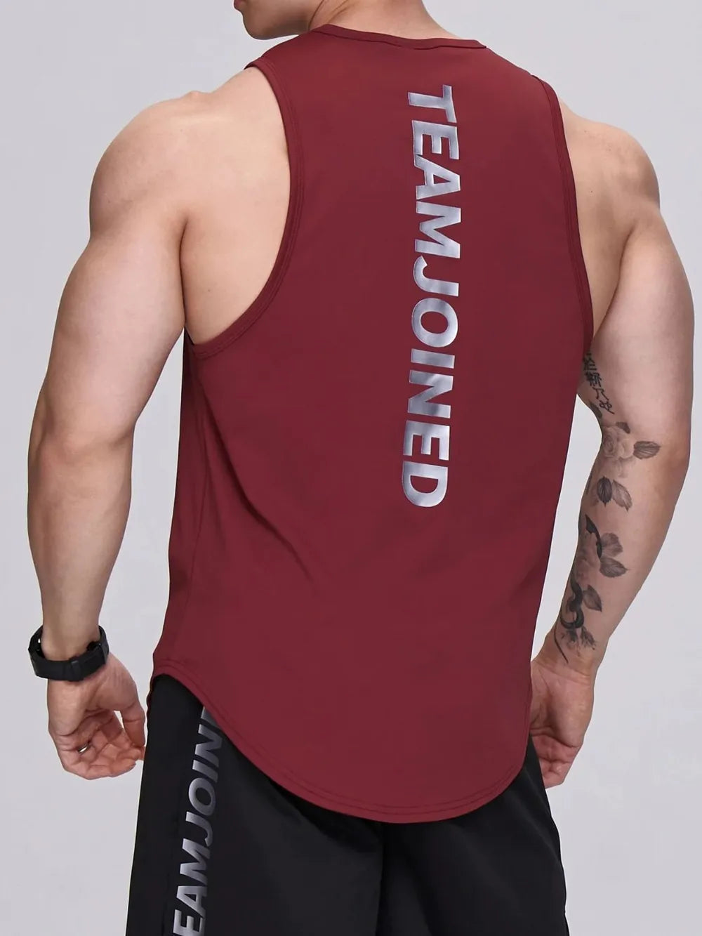 Burgundy performance tank top with silver TEAMJOINED graphic on back.