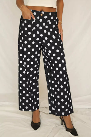 Black polka dot mid-rise wide leg trousers with pockets and button detail.