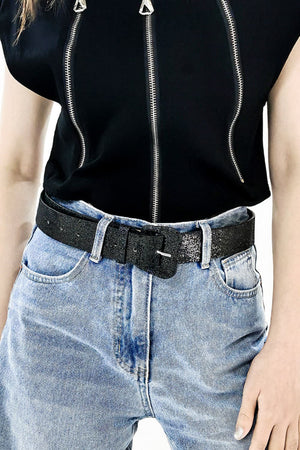 Black glitter belt with square buckle and multiple holes, worn with jeans.