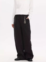 Black pinstripe wide-leg sweatpants with a pearl keychain detail.