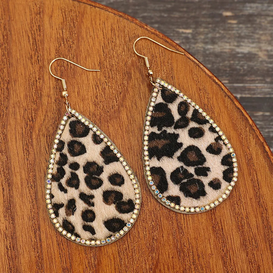 Leopard print teardrop earrings with crystal trim and gold hooks.