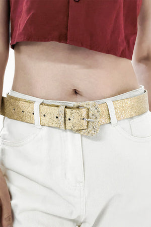 Gold glitter belt with a square buckle, worn with white jeans.