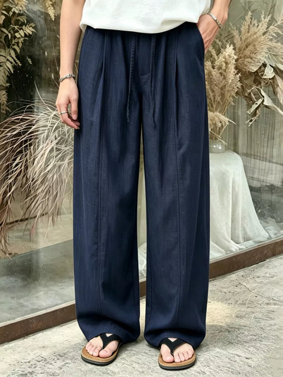 Dark blue wide-leg sweatpants with drawstring and front pleats.