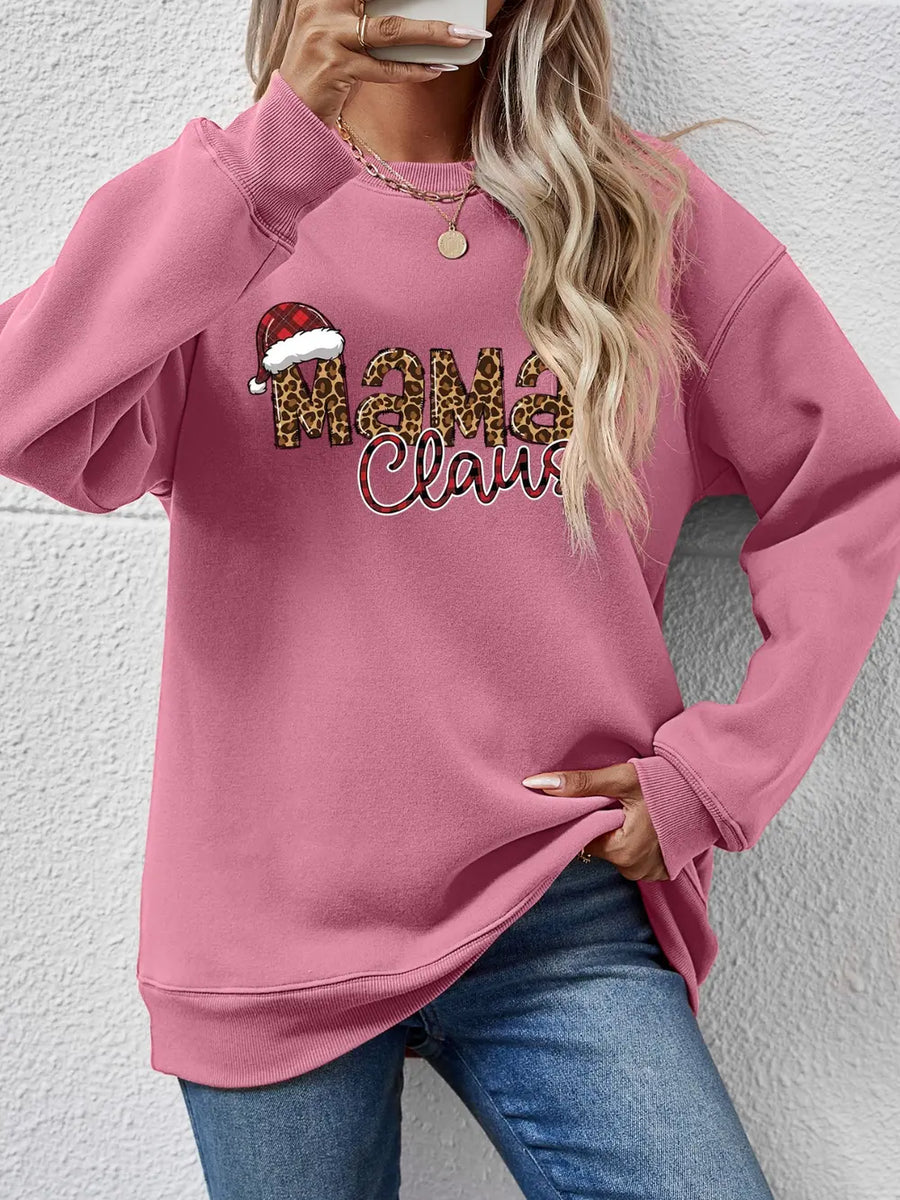 Blush pink crewneck sweatshirt with leopard print "Mama Claus" graphic and Santa hat detail.