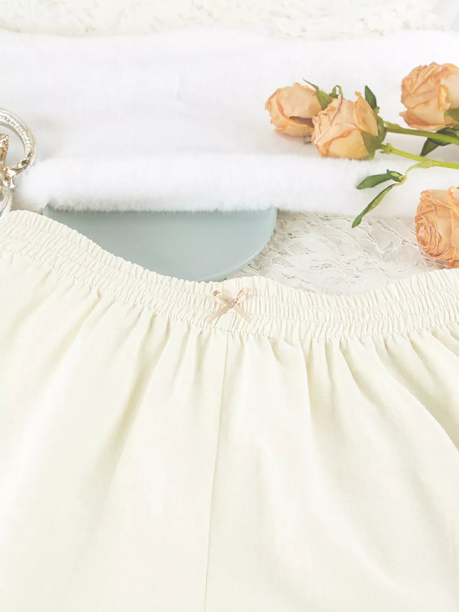 cream pajama set with hip-length top, mini shorts and button-front