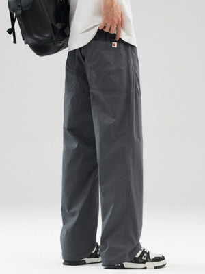 Oversized dark gray casual pants with a loose fit and two front pockets.
