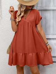 Rust red V-neck mini dress with short sleeves and a ruffled hem.