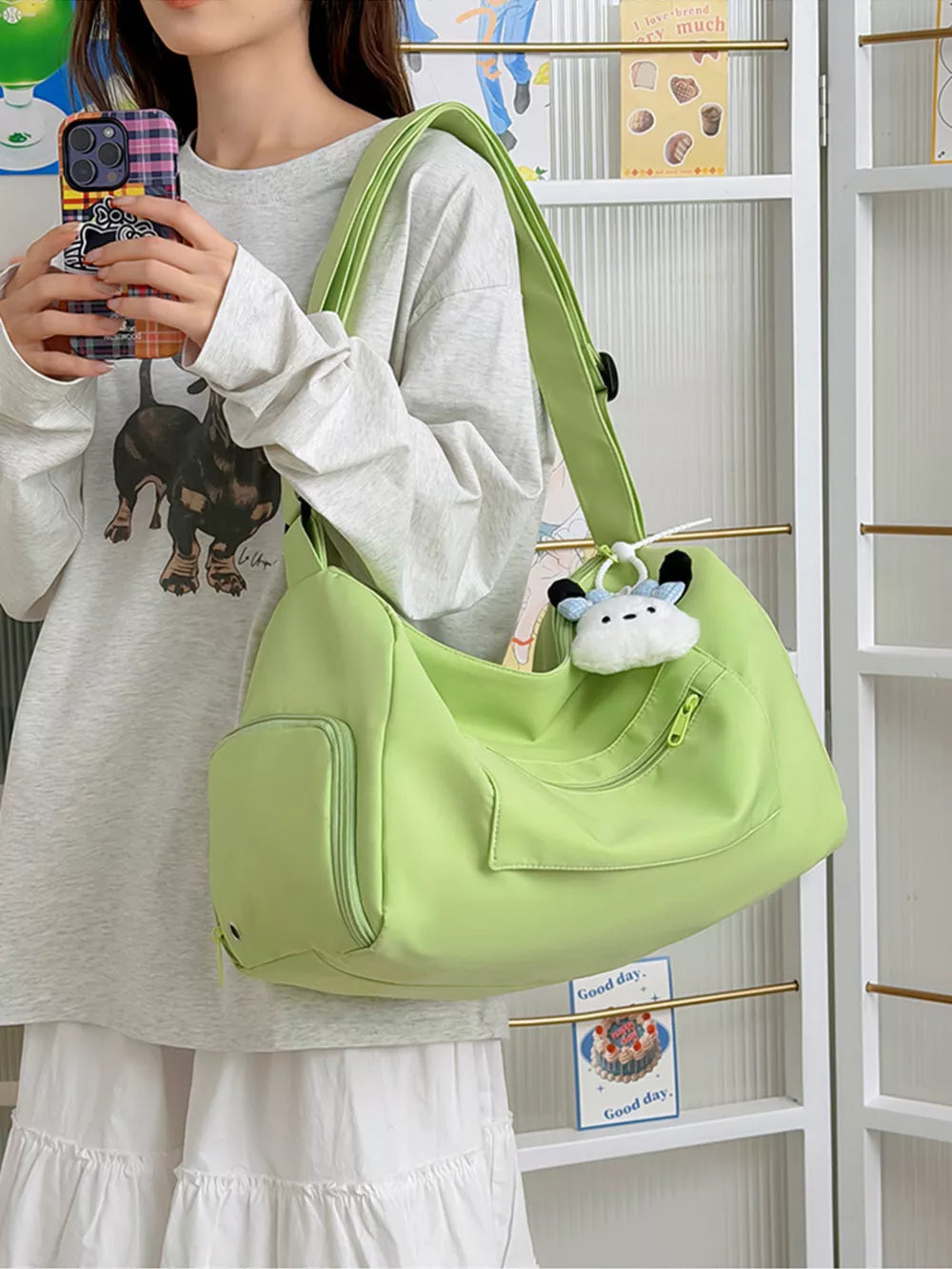 Vibrant light green adjustable travel bag with multiple pockets and a cute charm.