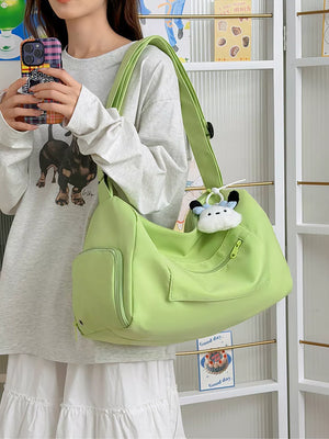 Vibrant light green adjustable travel bag with multiple pockets and a cute charm.