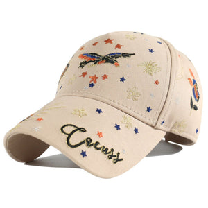 Khaki cotton baseball cap with intricate bird and star embroidery and "Circus" text.