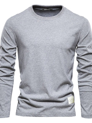 Gray textured crew-neck long-sleeve tee with a woven patch detail on the hem.