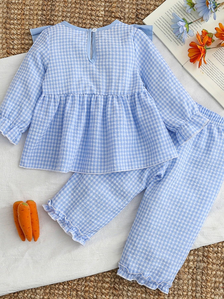 Blue gingham baby set with ruffled cuffs and hem, featuring carrot embroidery detail.