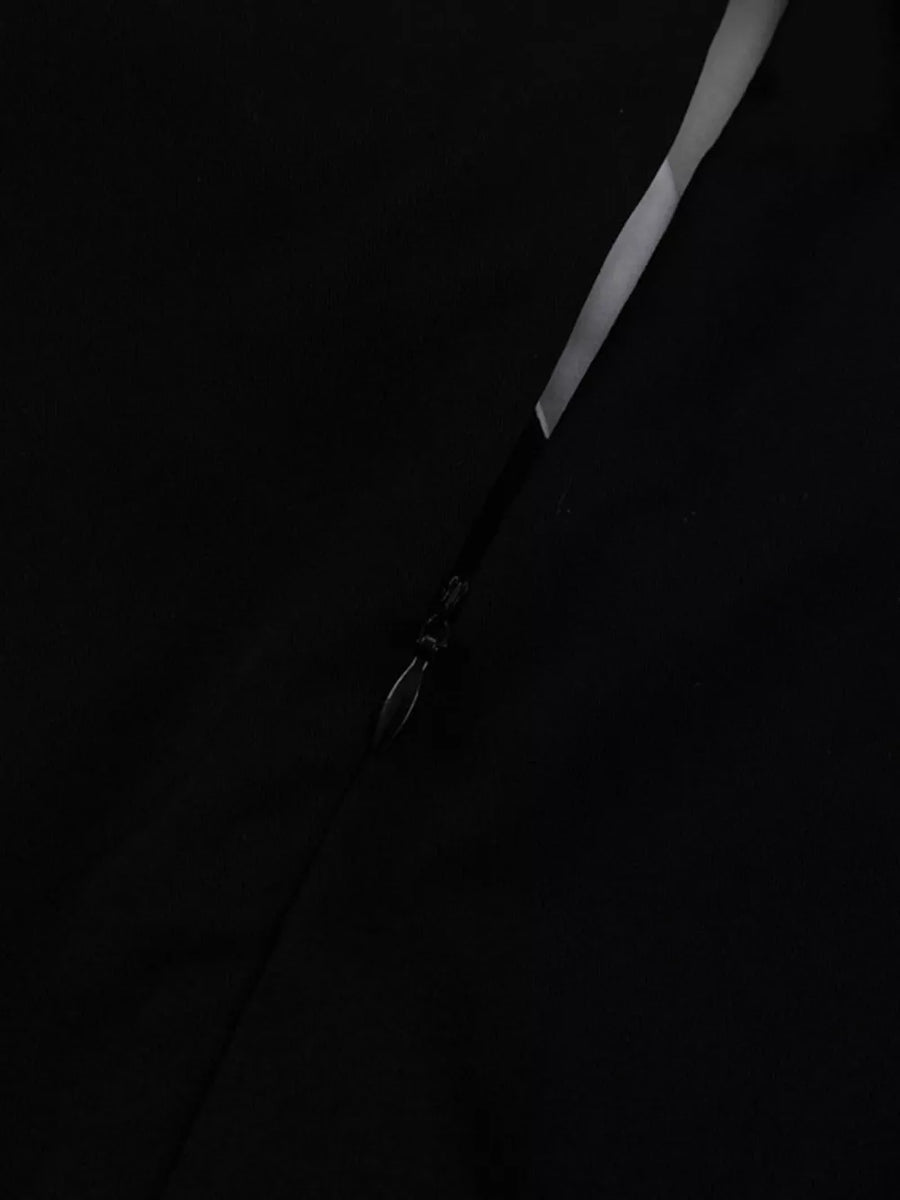 Black dress with a side zipper detail and a subtle sheen.